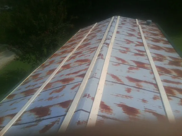 Rusted metal roof panels with new wood purlins before replacement — Storm Damage Roof Repair in Twain Harte by Roofing Brothers